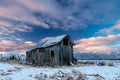 Rustic old barn on a farm in rural Idaho with winter snow on the ground