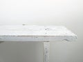 Rustic and old bench in solid wood painted white on white background. Retro and vintage style. Partial view Royalty Free Stock Photo