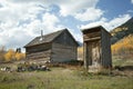 Rustic old cabin and outhouse in Fall Season Royalty Free Stock Photo