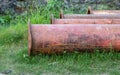 Rustic old dredging pipes stored on a meadowland close up shot Royalty Free Stock Photo