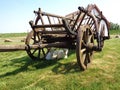 Rustic Old Horse Drawn Wagon with two young goats resting in his shadow Royalty Free Stock Photo