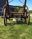 Rustic Old Horse Drawn Wagon with two young goats resting in his shadow Royalty Free Stock Photo