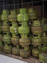 rustic old 3kg LPG cylinder tank tube can container being stacked on small store dispaly in indonesia