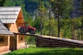 Rustic old red tractor on ramp of wooden barn Royalty Free Stock Photo