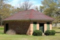 A rustic old southern weathered red brick rusted  tin roof garden shed building Royalty Free Stock Photo