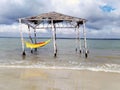 Rustic and old tent with hammock inside the beach. Deserted beach of Mangue Seco; Jandaira; Bahia; Brazil