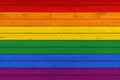 Rustic Old Weathered Wood Plank Background Texture in colours of LGBT Pride Flag Royalty Free Stock Photo