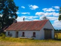 Rustic Old Whitewashed Irish Cottage with fiddler on roof Royalty Free Stock Photo