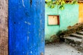 Rustic open blue door & turquoise & yellow wall Royalty Free Stock Photo