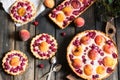 Rustic open pie with peach and raspberry, french galette . Peach tart. Raspberry tart. Tartalette with cream. Variety of bakery. Royalty Free Stock Photo