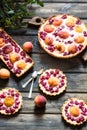 Rustic open pie with peach and raspberry, french galette . Peach tart. Raspberry tart. Tartalette with cream. Variety of bakery. Royalty Free Stock Photo