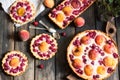 Rustic open pie with peach and raspberry, french galette . Peach tart. Raspberry tart. Tartalette with cream. Variety of bakery. Royalty Free Stock Photo