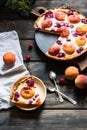 Rustic open pie with peach and raspberry, french galette . Peach tart. Raspberry tart. Tartalette with cream. Variety of bakery. Royalty Free Stock Photo