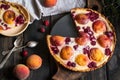 Rustic open pie with peach and raspberry, french galette . Peach tart. Raspberry tart. Tartalette with cream. Variety of bakery. Royalty Free Stock Photo