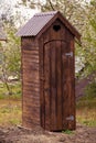 A rustic open toilet is in the garden. Rural lifestyle, latrine, toilet, outhouse, architecture, nature, garden, old, rustic, Royalty Free Stock Photo