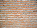 Rustic orange brick wall background with cement paste. Royalty Free Stock Photo