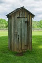 Rustic Outhouse in a Field Royalty Free Stock Photo