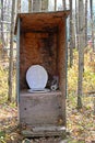A rustic outhouse at a hunting camp