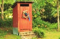 Rustic Outhouse Surrounded by Trees Royalty Free Stock Photo