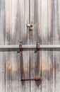 Rustic padlock on wooden entrance door in farmland. Royalty Free Stock Photo