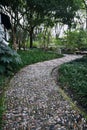 Rustic pathway made from natural stones winding its way through a lush green garden