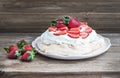 Rustic Pavlova cake with fresh strawberries and whipped cream ov Royalty Free Stock Photo