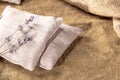 Rustic peasant pillows and dried lavender stems arranged on burlap background Royalty Free Stock Photo