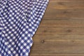 Rustic Picnic Wooden Table With Blue Folded Checkered Tablecloth