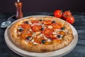 Rustic pizza with salami, mozzarella, fresh tomatoes, red onion, black olives and fresh basil. Home made pizza Royalty Free Stock Photo