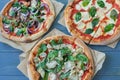 Rustic pizza with salami, mozzarella, olives and basil top view with copy space Royalty Free Stock Photo