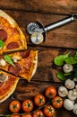 Rustic pizza with salami, mozzarella and spinach Royalty Free Stock Photo