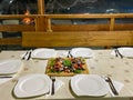 Rustic platter prepared for tourists with mici, pork neck on wooden platter