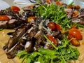 Rustic platter prepared for tourists with pork neck on wooden platter