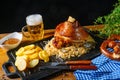 Rustic pork knuckle with sauerkraut, sweet mustard and fried potatoes Royalty Free Stock Photo