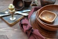 Rustic pottery and kitchen silver on wooden table
