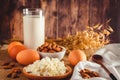 Rustic protein balanced diet food. Cottage cheese, eggs, nuts and milk on a wooden background Royalty Free Stock Photo