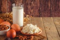 Rustic protein balanced diet food. Cottage cheese, eggs, nuts and milk on a wooden background Royalty Free Stock Photo