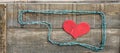 Rustic raw Love Oklahoma sign - barbed wire and wood rustic sign with red wooden heart inside Oklahoma shape on raw wooden planks