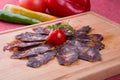 Rustic raw smoked meat sliced on chopping board Royalty Free Stock Photo
