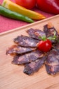 Rustic raw smoked meat sliced on chopping board Royalty Free Stock Photo