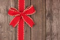 Red Christmas bow and ribbon side border on old wood Royalty Free Stock Photo