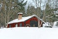 Rustic red wooden barn in snow Royalty Free Stock Photo