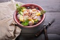 Rustic salad with octopus tentacles, boiled potatoes, cucumbers, fresh radishes, olives and dill