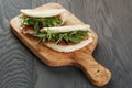 Rustic sandwiches with ham arugula and tomatoes in