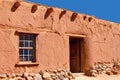 Rustic Santa Fe style adobe building with window door Royalty Free Stock Photo