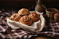 a rustic scene of cinnamon buns on a burlap cloth, beside cinnamon sticks