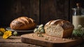 Rustic Sourdough Bread Still Life with Milk and Wildflowers on Wooden Table Royalty Free Stock Photo