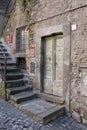 Vintage door, stone stairs, textured wall in old European alley