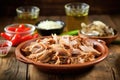 a rustic serving dish filled with carolina pulled pork and vinegar sauce