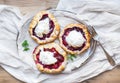 Rustic small galeta pies with fresh berries and vanilla ice-cream on silver dish over a piece of white linen fabric Royalty Free Stock Photo